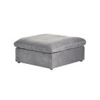 A gray linen upholstered ottoman with a cushioned top.