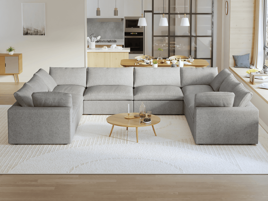 A modern, modular pit-style 8-seat sectional sofa in gray in a living room setting with white cushions and a clean, contemporary design.