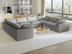 A modern, modular pit-style 8-seat sectional sofa in gray in a living room setting with white cushions and a clean, contemporary design.