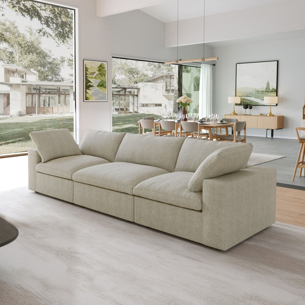 Khaki 3-seater sectional sofa in a modern living room with large windows and a dining area.
