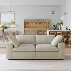 Khaki loveseat sofa in a modern living room with wooden furniture and decor.