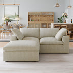 Khaki loveseat sectional sofa with a storage ottoman in a modern living room with a kitchen in the background.