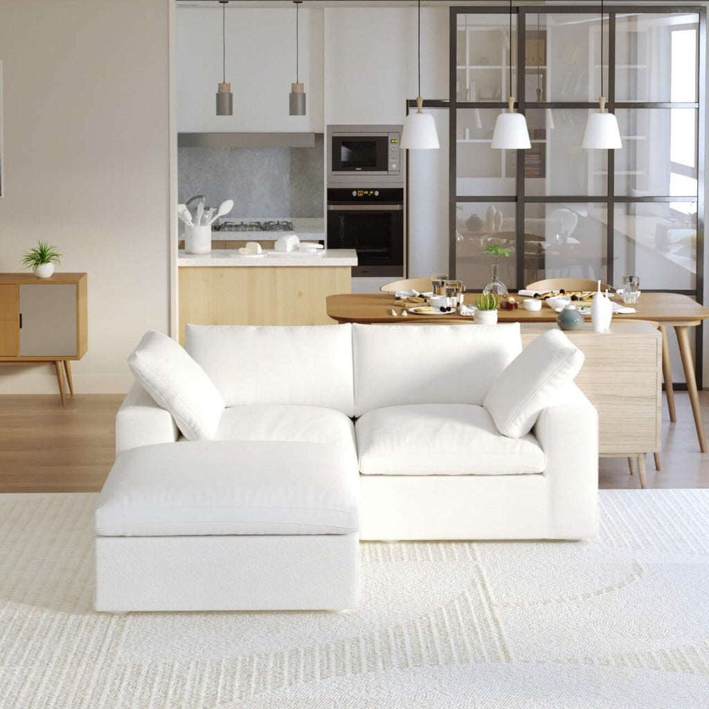 Cloud white modular 2-seat sectional with a storage ottoman in a modern living room setting.