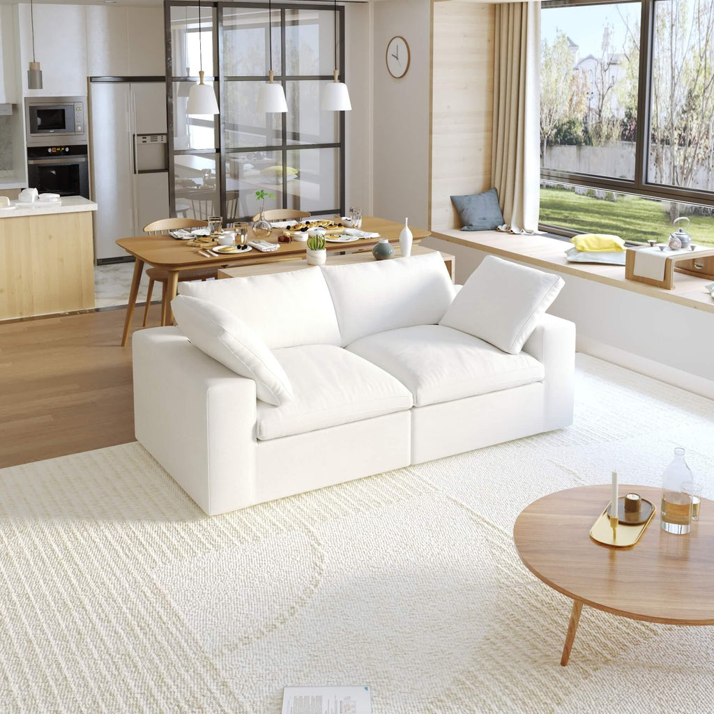 Cloud 2-seater sofa in a bright living room setting, featuring a white linen slipcover.