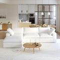 A white L-shaped modular sectional sofa with a storage ottoman in a modern living room setting.