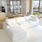 A white L-shaped modular sectional sofa with a storage ottoman in a modern living room setting.