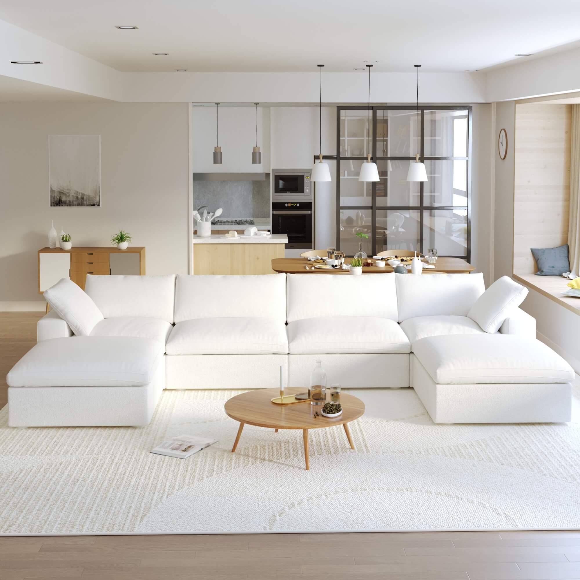 A large, U-shaped, white modular sectional sofa with storage ottoman in a modern living room setting.