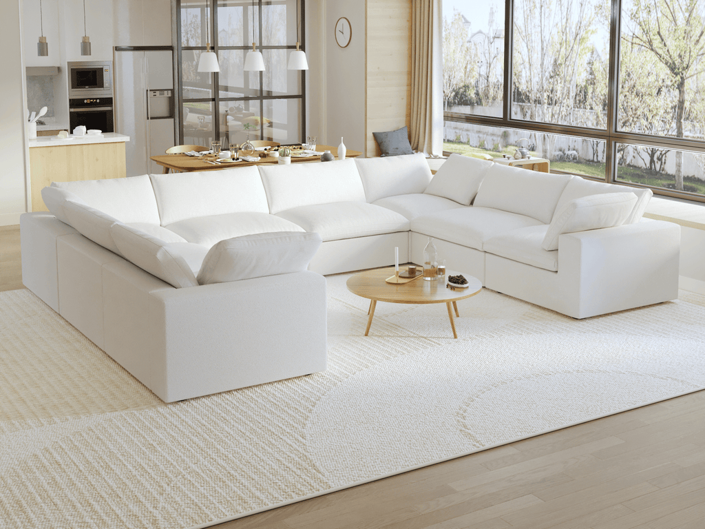 A modern, modular pit-style 8-seat sectional sofa in white in a living room setting with white cushions and a clean, contemporary design.