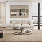 An 89-inch beige microfiber suede sofa with a solid hardwood frame, presented in a cold lightning in a living room setting with minimalistic decor, including an art print on the wall.