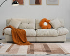 An 89-inch beige microfiber suede sofa with an orange decorations; solid hardwood frame, presented in a living room setting with minimalistic decor.