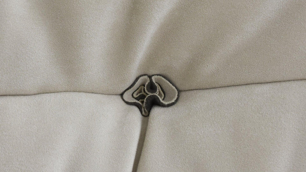 Close-up of a button design of a beige sofa