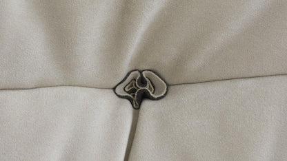Close-up of a button design of a beige sofa