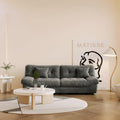 An 89-inch gray microfiber suede sofa in a warm lightning with a solid hardwood frame, presented in a living room.