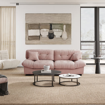 An 89-inch pink microfiber suede sofa with a solid hardwood frame, presented in a cold lightning in a living room setting with minimalistic decor, including an art print on the wall.
