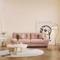 An 89-inch pink microfiber suede sofa with a solid hardwood frame, presented in a warm lightning in a living room setting.