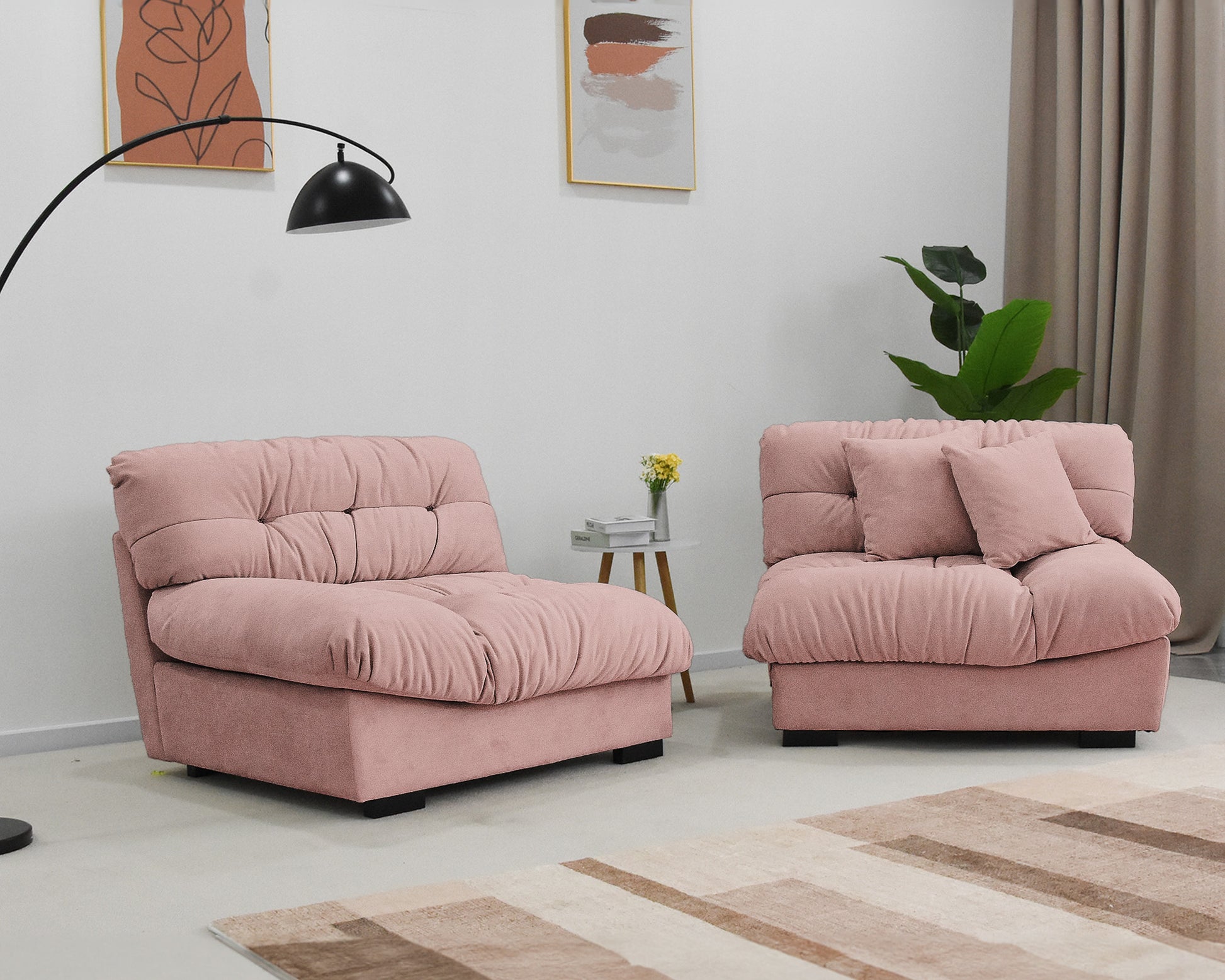An 89-inch pink microfiber suede sofa seat split in two with a solid hardwood frame, presented in a cold lightning in a living room setting with minimalistic decor.