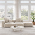 A beige corduroy 3-seat sectional lounger sofa with detachable armrests and removable covers, positioned in a bright room with large windows.