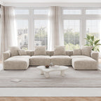 A beige corduroy modular sectional sofa with detachable armrests and removable covers, arranged in a U-shape configuration in a room with a light interior.