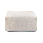 A beige corduroy modular ottoman with removable covers, presented in a minimalist style against a white background.