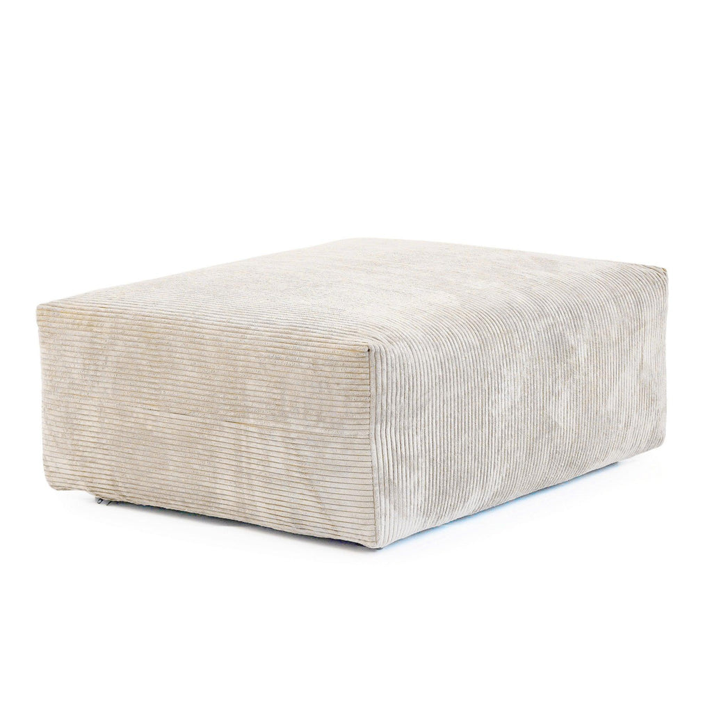 Beige corduroy ottoman on a white background