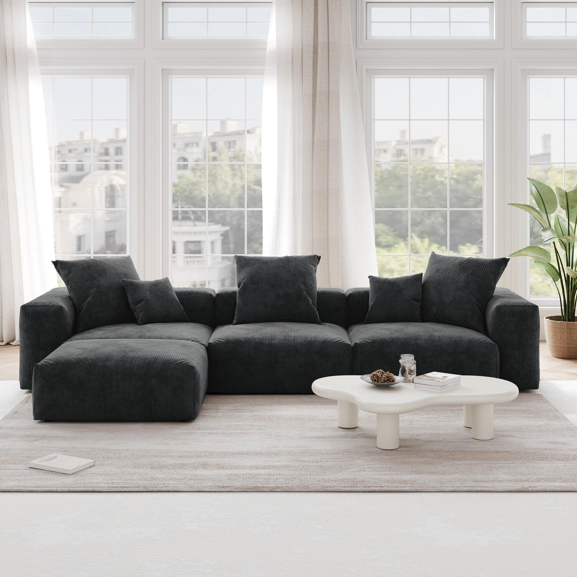A black L-shaped corduroy modular sofa with detachable armrests and removable covers, pet-friendly, displayed in a bright living space.
