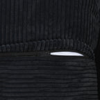 Close-up of a zipper on a cover of a black corduroy sofa