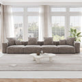 A brown corduroy 4-seat sectional modular sofa with detachable armrests and removable covers, designed to seat four people, displayed in a bright room with large windows.