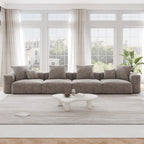 A brown corduroy 4-seat sectional modular sofa with detachable armrests and removable covers, designed to seat four people, displayed in a bright room with large windows.