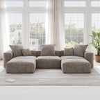 A brown corduroy U-shaped sectional modular sofa with detachable armrests and removable covers, placed in a room with large windows.