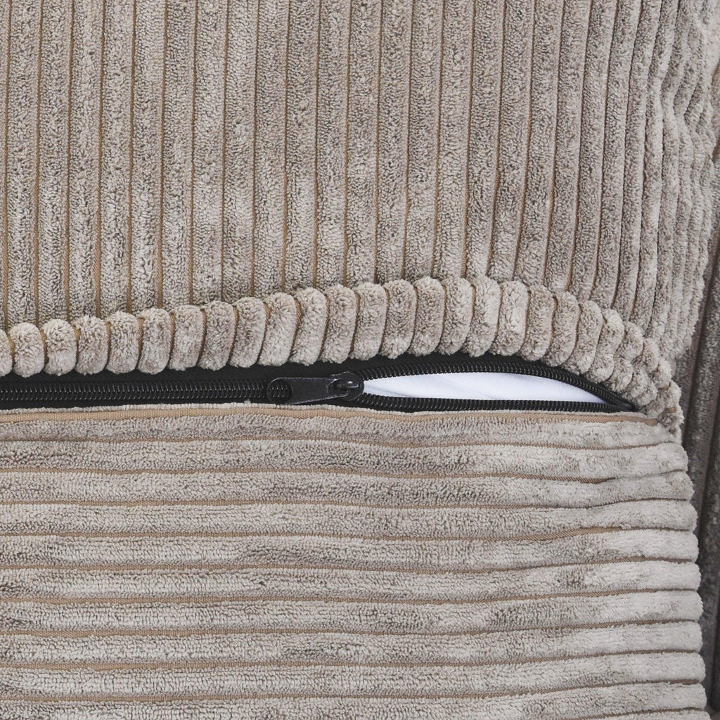 Close-up of a zipper on a brown corduroy sofa cover