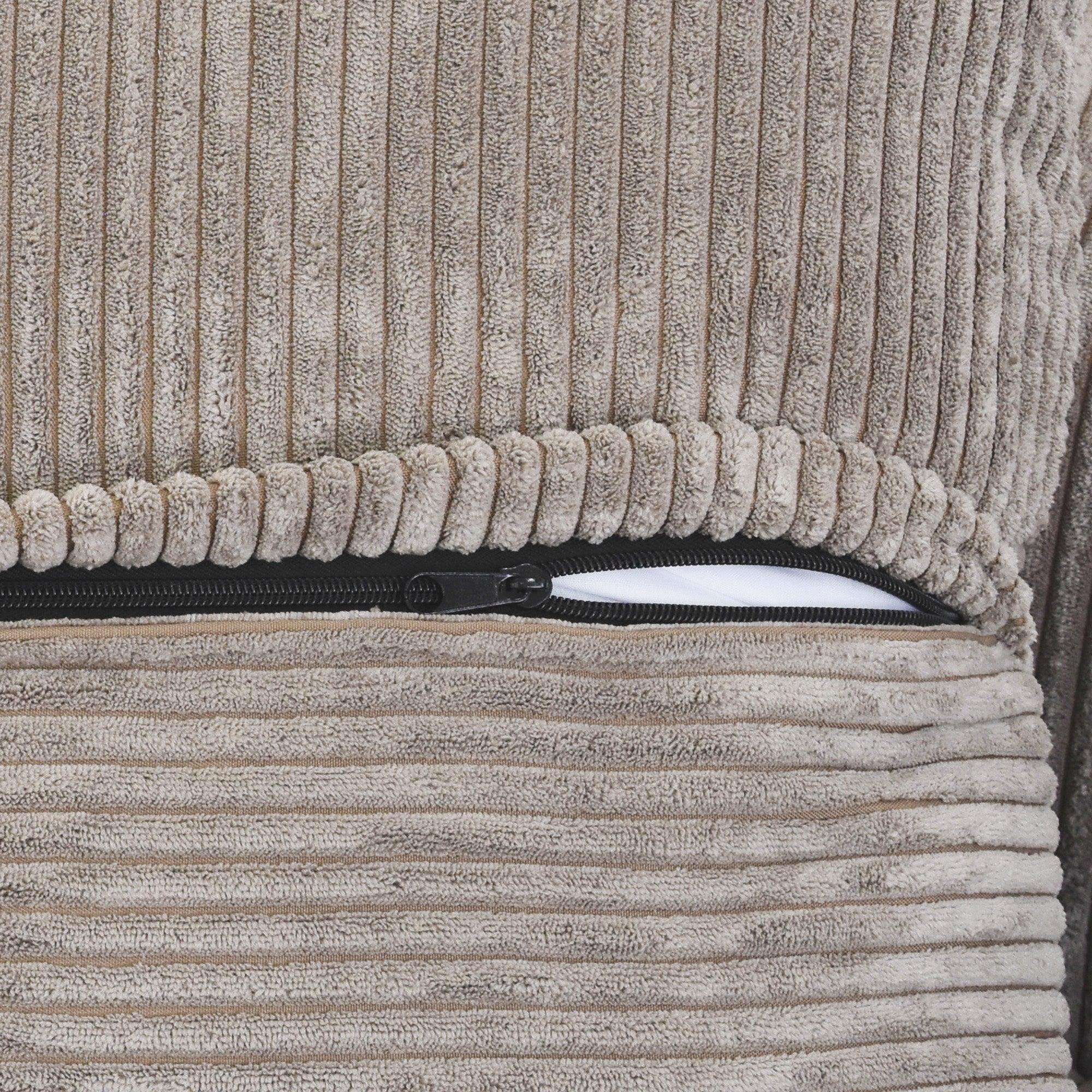 Close-up of a zipper on a brown corduroy sofa cover