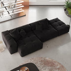 A modern, black 3-seat modular lounger sofa in white color with wide armrests and multiple accent pillows, arranged in a living room setting.