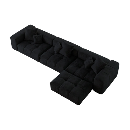 Black L-shaped sofa with a unique design on a white background