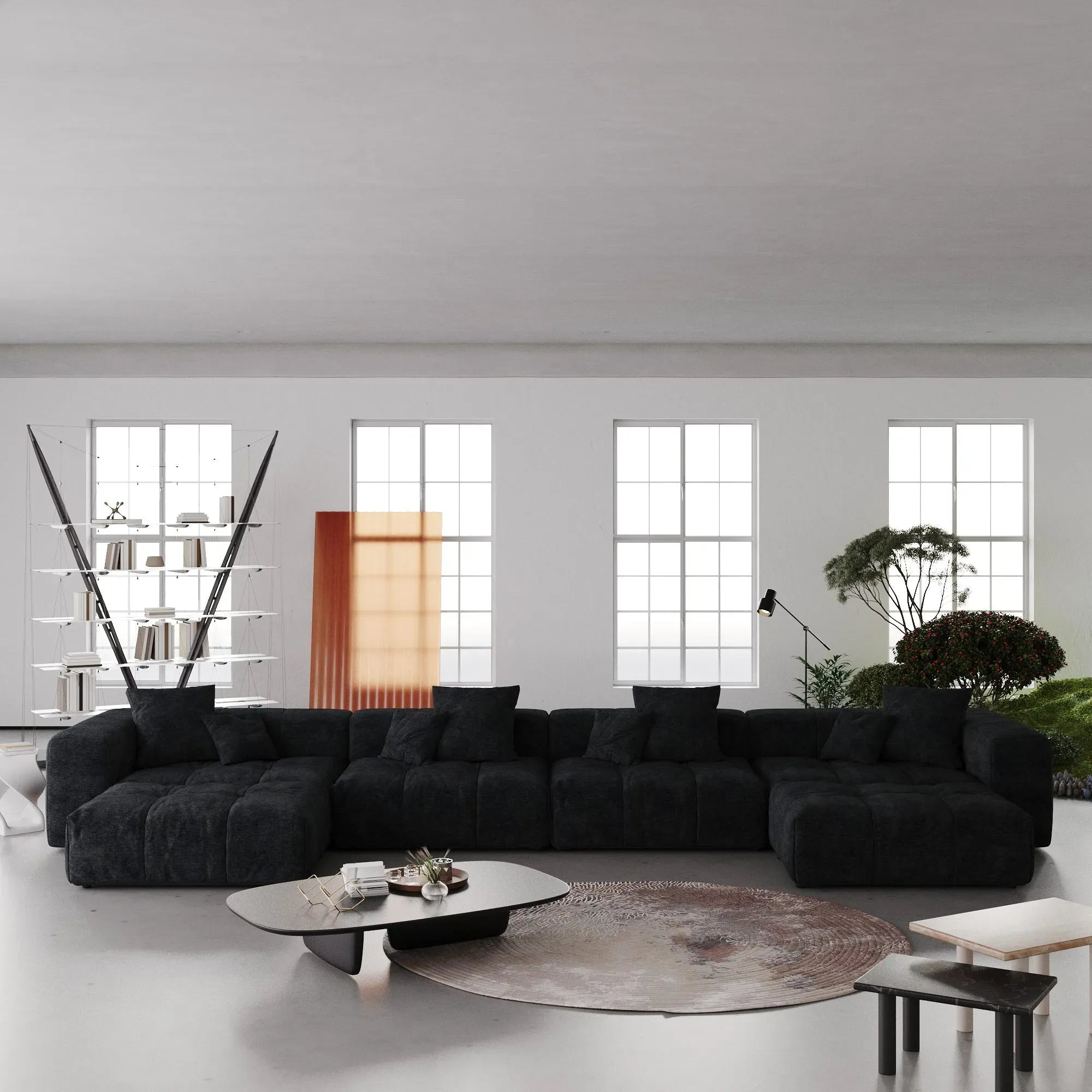 Modern living room with a large black U-shaped sectional sofa and decorative elements.