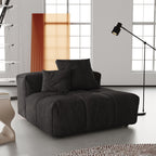 Black armless seat with cushions in a modern living room setting