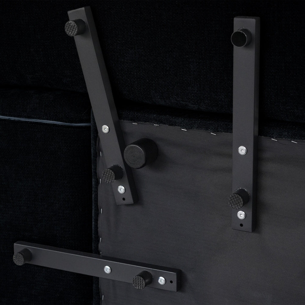 Underside frame and modular connectors of a black linen chair