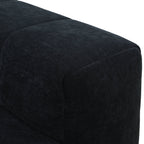 Close-up of a black upholstered armrest of a sofa