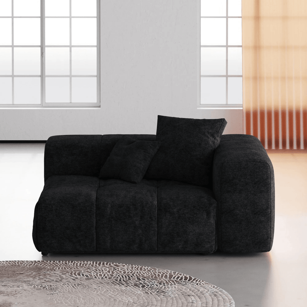 Black linen armrest left chair in a modern living room with large windows.