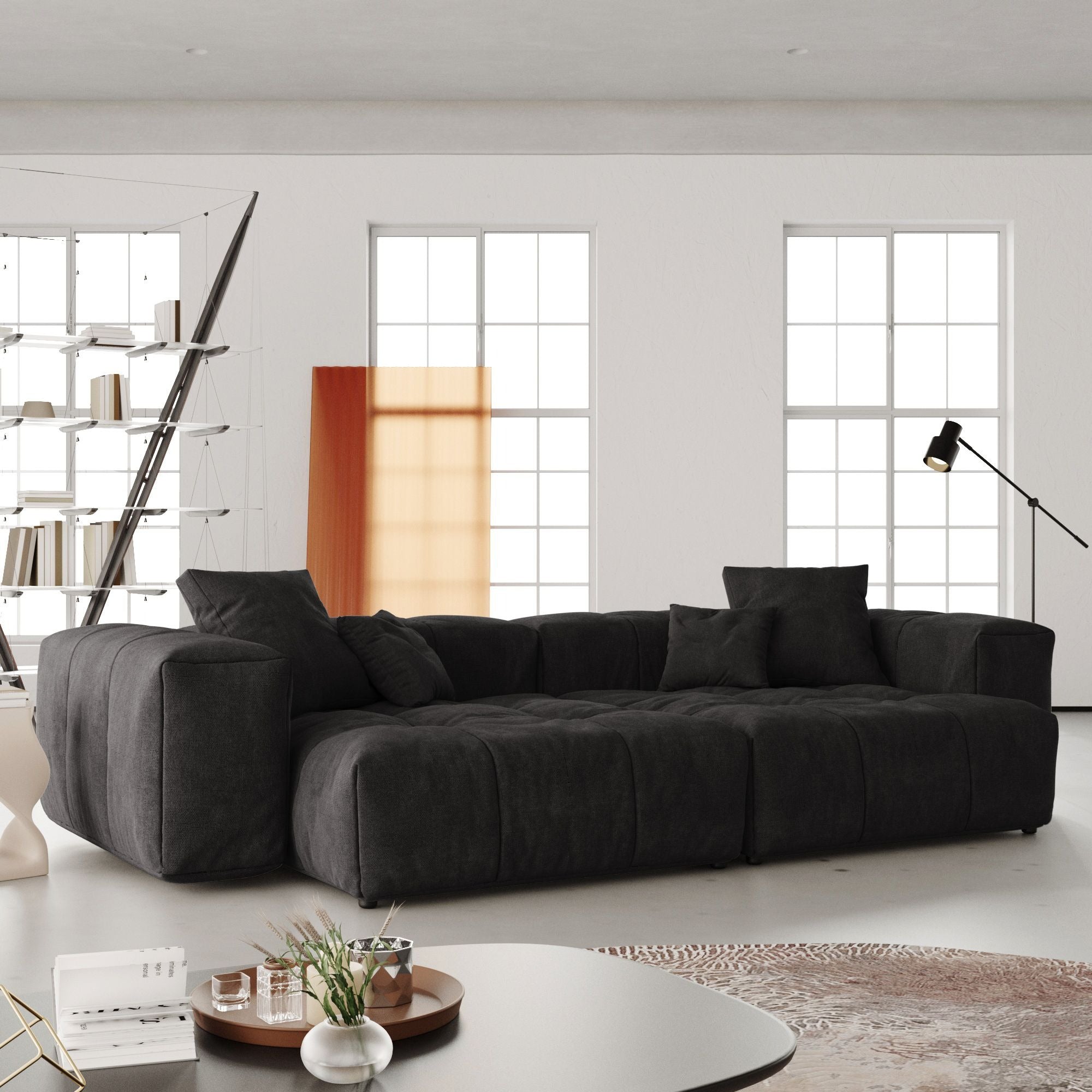 Black loveseat sofa in a modern living room with large windows.