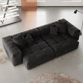 Black sectional loveseat sofa in a modern living room setting