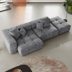 Gray 3-seat lounger sectional sofa in a modern living room setting with a round rug.