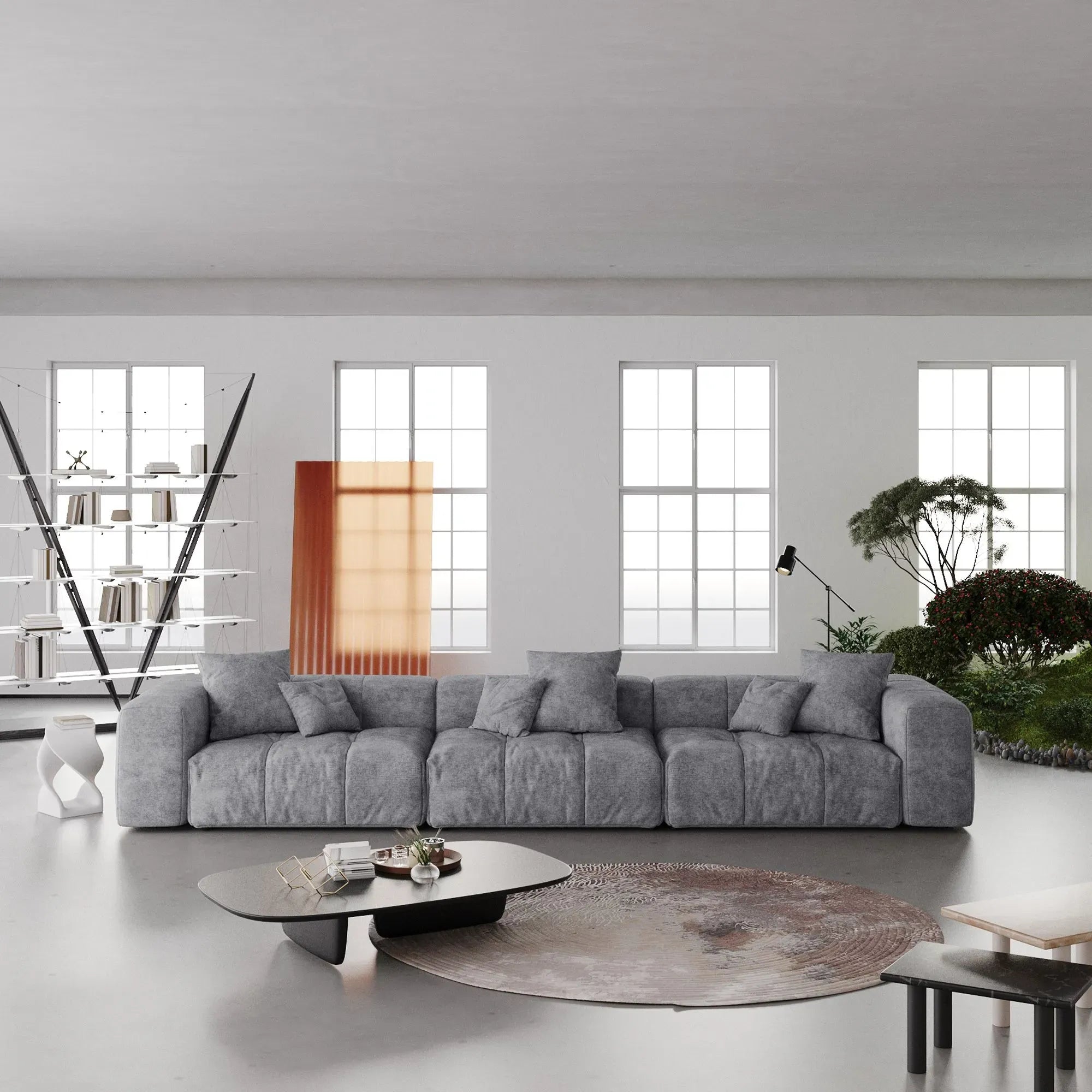Modern living room with a large gray 3-seater sofa, coffee table, and decorative elements.