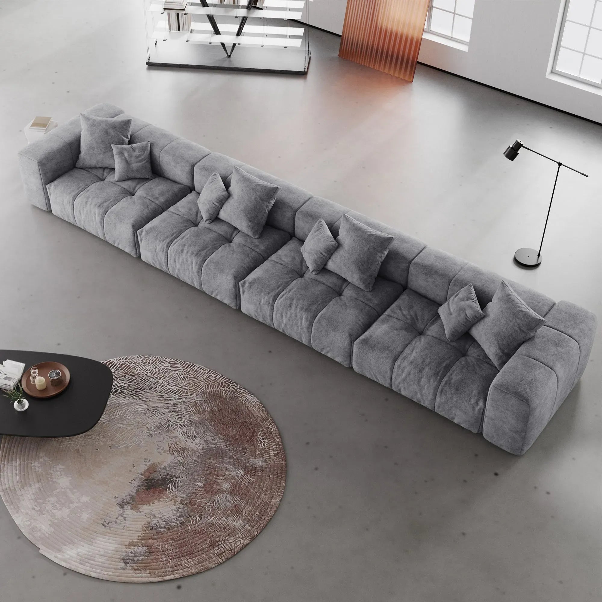 Gray 4-seater sofa with cushions in a modern living room setting