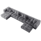 Gray U-shaped sectional sofa with cushions on a white background