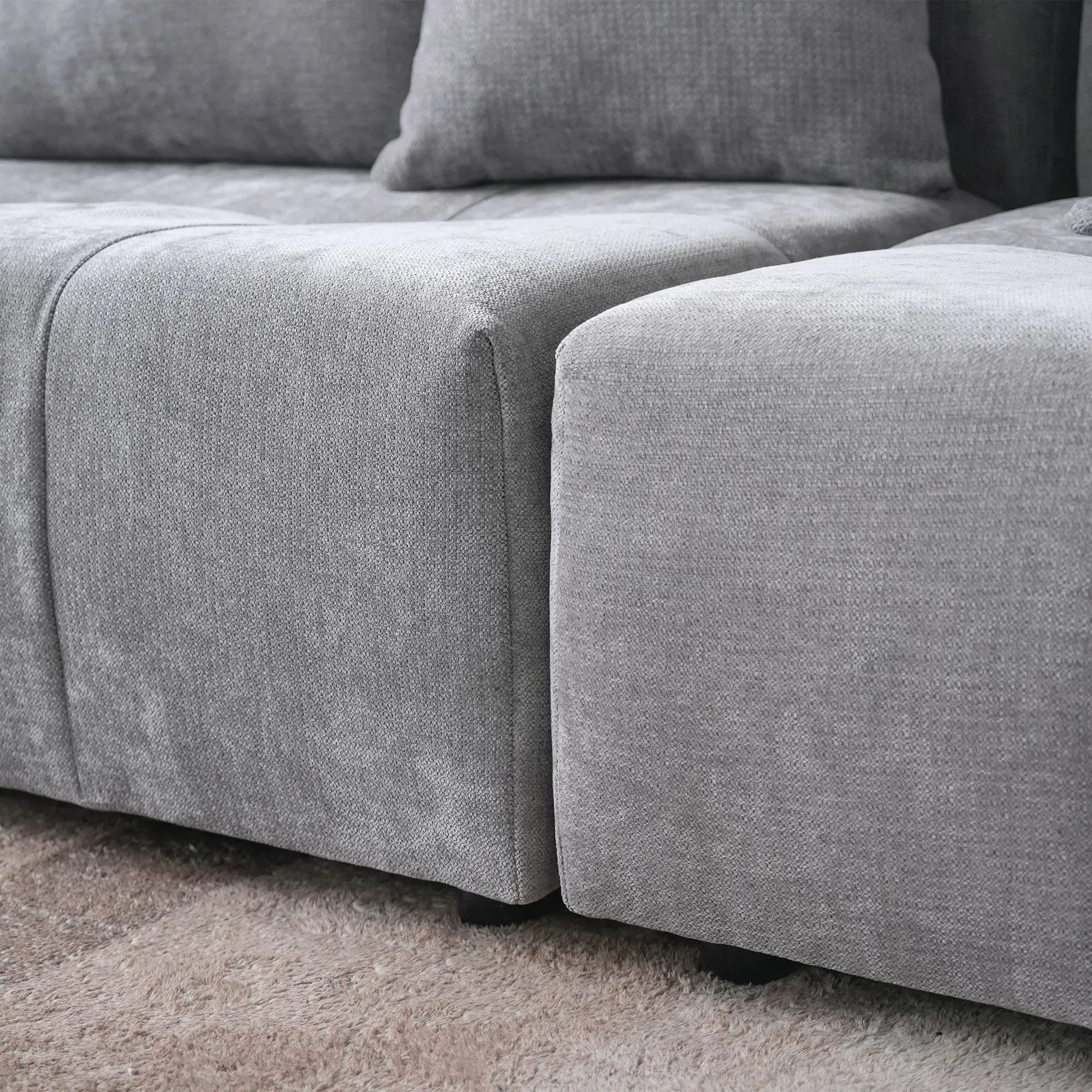 Gray sectional sofa on a carpeted floor