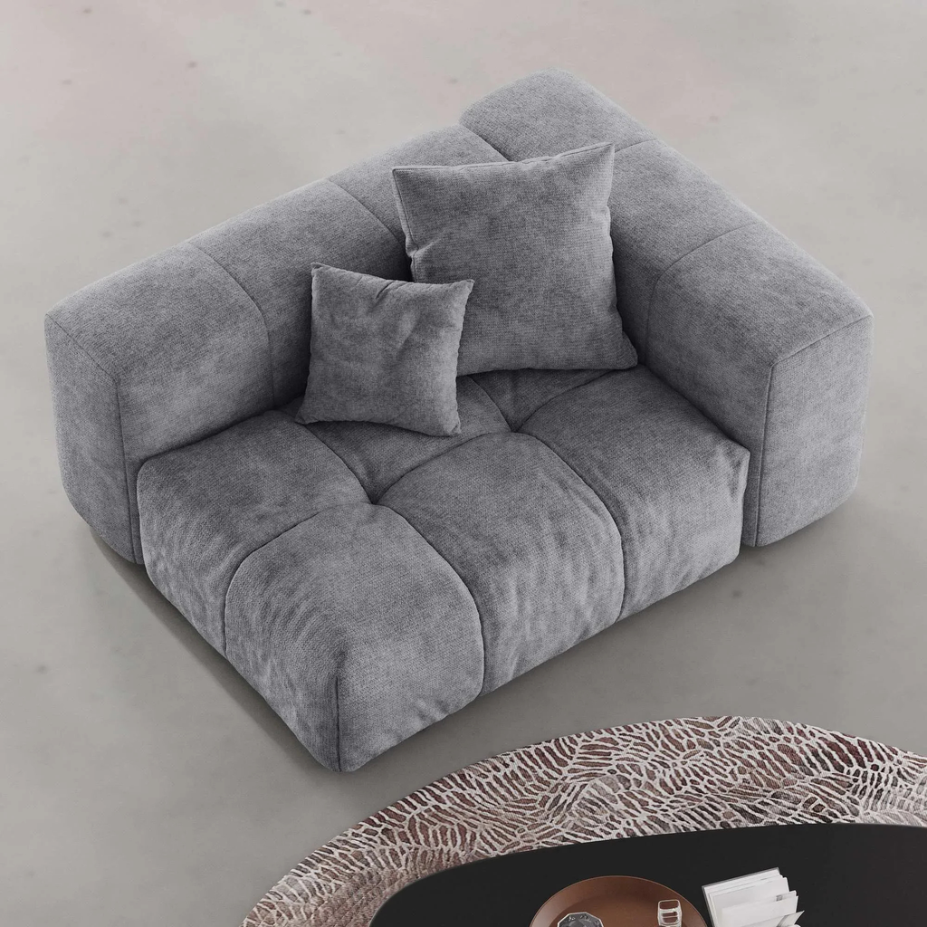 Gray left armrest chair with cushions on a light gray floor