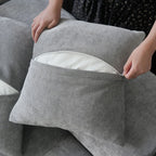 Close-up of an unzipped pillow case of a gray sofa