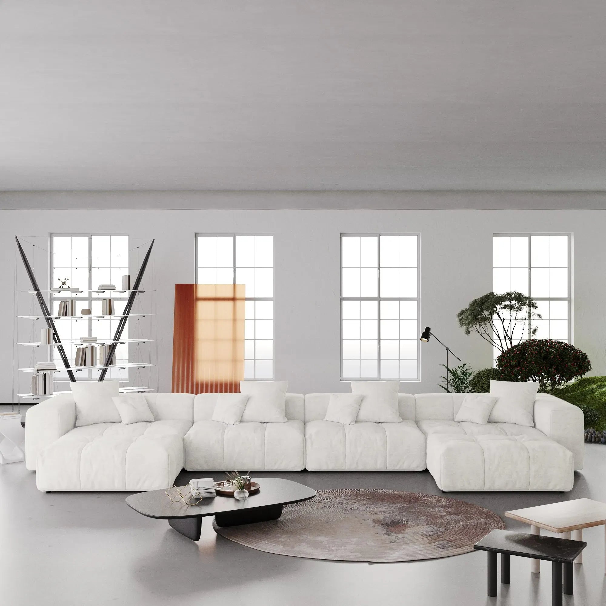 Modern white U-shaped sectional sofa in a minimalistic living room with large windows.