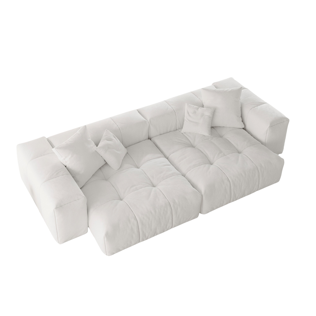White loveseat sofa with tufted design on a white background