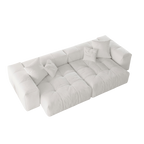 White loveseat sofa with tufted design on a white background